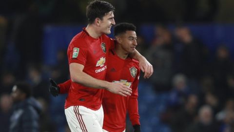 Manchester United's Harry Maguire and Jesse Lingard, right, celebrate at the end of the English League Cup soccer match between Chelsea and Manchester United at Stamford Bridge in London, Wednesday, Oct. 30, 2019. Manchester United won 2-1. (AP Photo/Ian Walton)