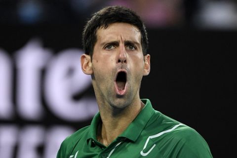 Serbia's Novak Djokovic reacts during his men's singles final against Austria's Dominic Thiem at the Australian Open tennis championship in Melbourne, Australia, Sunday, Feb. 2, 2020. (AP Photo/Andy Brownbill)