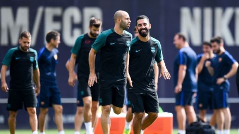 Javier Mascherano (L) and Ardan Turan of FC Barcelona warm up during a training session ahead of their UEFA Champions League Group C match against Celtic FC