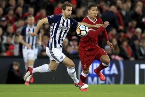 West Bromwich Albion's Craig Dawson (left) and Liverpool's Roberto Firmino battle for the ball during the English FA Cup, fourth round soccer match at the Anfield stadium, Liverpool, England, Saturday Jan. 27, 2018. (Peter Byrne/PA via AP)