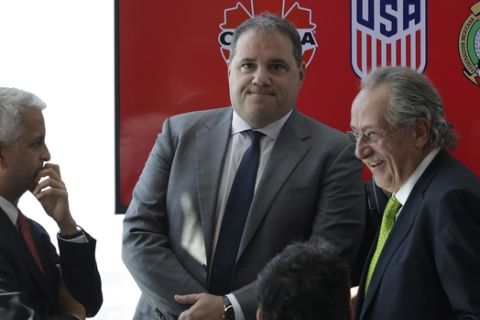 Victor Montagliani, left, President of the Canadian Soccer Association, Sunil Gulati, center, President of the United States Soccer Federation, and Decio de Maria, President of the Mexican Football Federation, arrive for a news conference, Monday, April 10, 2017, in New York. The three soccer federations announced a joint bid for the 2026 World Cup. (AP Photo/Mark Lennihan)
