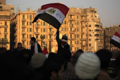 Egyptians wave their national flag as thousands march in a protest from Al-Ahly club to the headquarters of the ministry of interior in Cairo on February 2, 2012 against the previous day's deadly riots after a football match. Egypt began three days of mourning after 74 people were killed in an eruption of violence at a football match that sparked new anger against the military rulers for failing to ensure security. AFP PHOTO/MAHMUD HAMS (Photo credit should read MAHMUD HAMS/AFP/Getty Images)