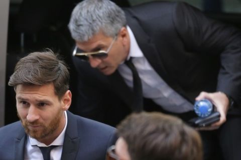 Barcelona soccer player Lionel Messi, left, arrives at a court in Barcelona, Spain, Thursday, June 2, 2016. Messi's tax trial began Tuesday. Messi and his father, Jorge Horacio, have been charged with three counts of tax fraud. They could be sentenced to nearly two years in prison if found guilty of defrauding Spain's tax authority of 4.1 million euros ($4.5 million) from 2007-09. (AP Photo/Manu Fernandez)