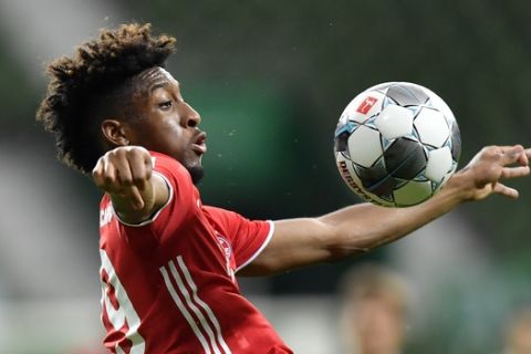 Bayern's Kingsley Coman controls the ball during the German Bundesliga soccer match between Werder Bremen and Bayern Munich in Bremen, Germany, Tuesday, June 16, 2020. Because of the coronavirus outbreak all soccer matches of the German Bundesliga take place without spectators. (AP Photo/Martin Meissner, Pool)
