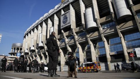 Security unit with dogs stand outside the Santiago Bernabeu stadium ahead of a Copa Libertadores final soccer match between River Plate and Boca Juniors in Madrid, Spain, Sunday, Dec. 9, 2018. (AP Photo/Thanassis Stavrakis)