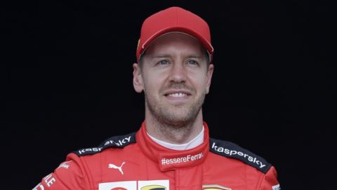 Ferrari driver Sebastian Vettel of Germany poses for a photo at the Australian Formula One Grand Prix in Melbourne, Thursday, March 12, 2020. (AP Photo/Rick Rycroft)