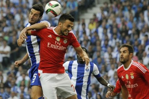 Portos Ivan Marcano, left, fights for the ball with Benficas Andreas Samaris, front centre, during the Portuguese League soccer match between FC Porto and SL Benfica at Porto's Dragao stadium in Porto, Portugal, Sunday, Sept. 20, 2015. (AP Photo/Paulo Duarte)