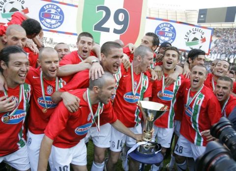 Juventus's Alessandro del Piero holds the trophy after his team clinched its second straight Serie A soccer title, at the Bari San Nicola stadium, Italy, Sunday, May 14, 2006. Juventus defeated Reggina 2-0. (AP Photo/Antonio Calanni)
