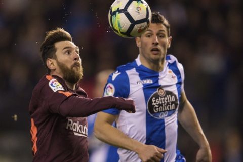 Barcelona's Lionel Messi, left, fights for the ball with Deportivo's Fabian Schar during a Spanish La Liga soccer match between Deportivo and Barcelona at the Riazor stadium in A Coruna, Spain, Sunday, April 29, 2018. (AP Photo/Lalo R. Villar)