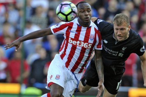 Stoke's Saido Berahino, left, and Liverpool's Ragnar Klavan battle for the ball during the English Premier League soccer match between Stoke City and Liverpool at the Britannia Stadium, Stoke on Trent, England, Saturday, March. 18, 2017. (AP Photo/Rui Vieira)