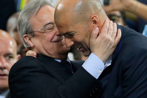 Real Madrid's headcoach Zinedine Zidane, right, is embraced by Real president Florentino Perez at the end of the Champions League final soccer match between Real Madrid and Atletico Madrid at the San Siro stadium in Milan, Italy, Saturday, May 28, 2016.  (AP Photo/Manu Fernandez)