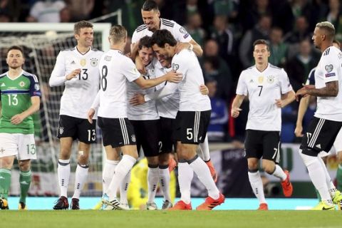 Germany's Sebastian Rudy, fourth from left, celebrates scoring his side's first goal of the game with his team-mates during the World Cup Group C qualifying soccer match between Germany and Northern Ireland at Windsor Park, Belfast, Northern Ireland. Thursday, Oct. 5, 2017. (Brian Lawless/PA via AP)