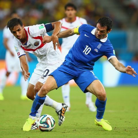 RECIFE, BRAZIL - JUNE 29:  Bryan Ruiz of Costa Rica challenges Giorgos Karagounis of Greece during the 2014 FIFA World Cup Brazil Round of 16 match between Costa Rica and Greece at Arena Pernambuco on June 29, 2014 in Recife, Brazil.  (Photo by Paul Gilham/Getty Images)