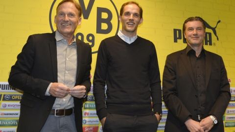 Borussia Dortmund's new head coach Thomas Tuchel, center, is presented by CEO Han-Joachim Watzke, left, and sporting manager Michael Zorc, right, at the stadium in Dortmund, Germany, Wednesday, June 3, 2015. Tuchel follows Juergen Klopp, who left the German first division soccer club BVB after seven years. (AP Photo/Martin Meissner)