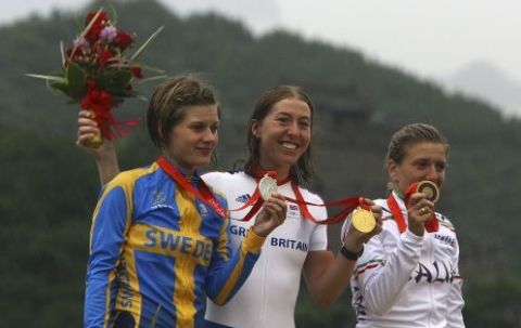 Britain's Nicole Cooke, center, shows her gold medal of the Women's Road Cycling Race, flanked by Tatiana Guderzo, of Italy, right, who clinched the silver, and Sweden's Emma Johansson, bronze, at the Beijing 2008 Olympics in Beijing, Sunday, Aug. 10, 2008 (AP Photo/Paul Gilham/, Pool)