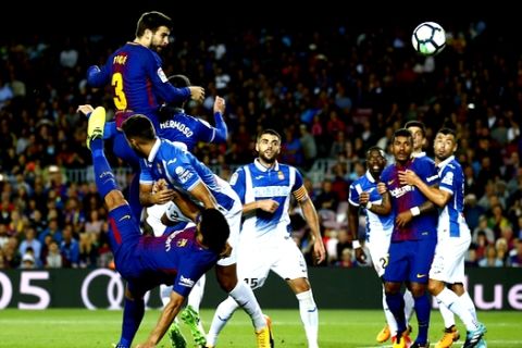 FC Barcelona's Gerard Pique, left, heads for the ball to score during the Spanish La Liga soccer match between FC Barcelona and Espanyol at the Camp Nou stadium in Barcelona, Spain, Saturday, Sept. 9, 2017. (AP Photo/Manu Fernandez)