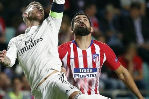 Real Madrid's Sergio Ramos, left, and Atletico's Diego Costa challenge for the ball during the UEFA Super Cup final soccer match between Real Madrid and Atletico Madrid at the Lillekula stadium in Tallinn, Estonia, Wednesday, Aug. 15, 2018. (AP Photo/Mindaugas Kulbis)