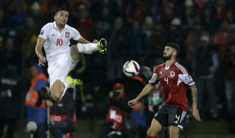 Serbia's Dusan Tadic, left, fights for the ball with Albania's Elseid Hysaj during the group I Euro 2016 qualifying match between Albania and Serbia at the Elbasan Arena in Elbasan, central Albania, Thursday, Oct. 8, 2015. Serbia won 2-0. (AP Photo/Thanassis Stavrakis)