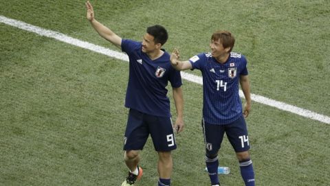Japan's Shinji Okazaki and Takashi Inui, right, wave to the stands at the end of the group H match between Japan and Poland at the 2018 soccer World Cup at the Volgograd Arena in Volgograd, Russia, Thursday, June 28, 2018. (AP Photo/Themba Hadebe)