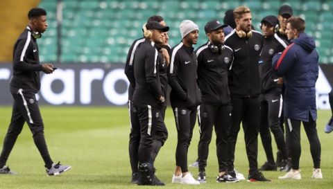 Paris Saint Germain's Neymar, centre with headphones, with teammates during a walkaround of Celtic Park in Glasgow, Scotland, Monday Sept. 11, 2017.  PSG face off against Celtic in a Champions League Group stage match on Tuesday. (Andrew Milligan/PA via AP)