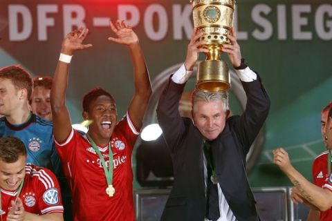 Bayern head coach Jupp Heynckes, second right, lifts the trophy during the winning ceremony for the German Soccer Cup Final between FC Bayern Munich and VfB Stuttgart at the Olympic Stadium in Berlin, Germany, Saturday, June 1, 2013. Bayern defeated Stuttgart by 3-2. (AP Photo/Michael Sohn)