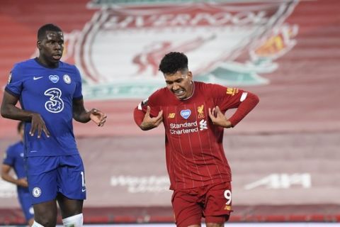 Liverpool's Roberto Firmino, center, celebrates scoring his side's fourth goal during the English Premier League soccer match between Liverpool and Chelsea at Anfield stadium in Liverpool, England, Wednesday, July 22, 2020. (Laurence Griffiths, Pool via AP)