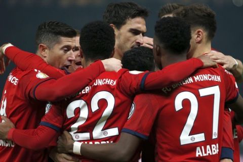 Bayern's scorer Serge Gnabry and his teammates celebrate their side's first goal during a German Soccer Cup round of sixteen match between Hertha BSC Berlin and FC Bayern Munich in Berlin, Germany, Wednesday, Feb. 6, 2019. (AP Photo/Michael Sohn)