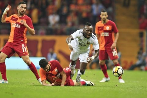 Ostersund's Samuel Mensah, center, is tackled during an UEFA Europa League second qualifying round, soccer match against Galatasaray, in Istanbul, Thursday, July 20, 2017.(AP Photo/Lefteris Pitarakis)