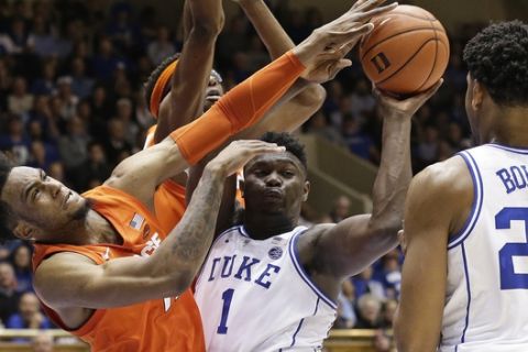 Duke's Zion Williamson (1) looks to pass to Marques Bolden (20) as Syracuse's Oshae Brissett blocks during the second half of an NCAA college basketball game in Durham, N.C., Monday, Jan. 14, 2019. Syracuse won 95-91. (AP Photo/Gerry Broome)