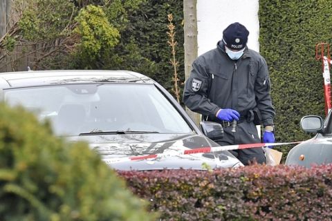 Police investigators search for evidence at the hedge near the team hotel of Bundesliga soccer club Borussia Dortmund in Dortmund, Germany, Wednesday, April 12, 2017, the day after the team bus was damaged in an explosion which injured a player and a police officer. (AP Photo/Martin Meissner)