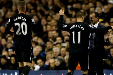 Evertons Kevin Mirallas, centre, celebrates after scoring the opening goal of the game with his manager Roberto Martinez, right, during their English Premier League soccer match between Tottenham Hotspur and Everton at White Hart Lane stadium in London Sunday, Nov. 30,  2014. (AP Photo/Alastair Grant)