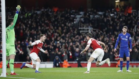 Arsenal's Laurent Koscielny, second right celebrates after scoring his sides2nd goal during the English Premier League soccer match between Arsenal and Chelsea at the Emirates stadium in London, Saturday, Jan. 19, 2019. (AP Photo/Frank Augstein)