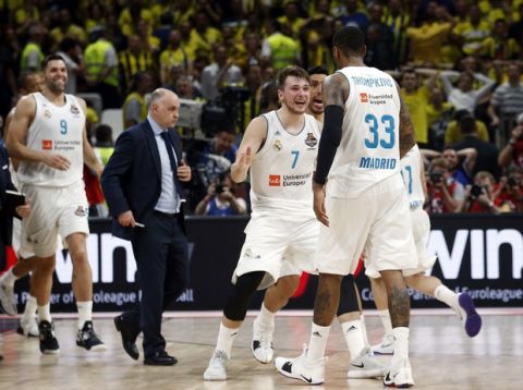 Real Madrid's Luka Doncic reacts with Real Madrid's Trey Thompkins after winning their Final Four Euroleague final basketball match against Fenerbahce in Belgrade, Serbia, Sunday, May 20, 2018. (AP Photo/Darko Vojinovic)