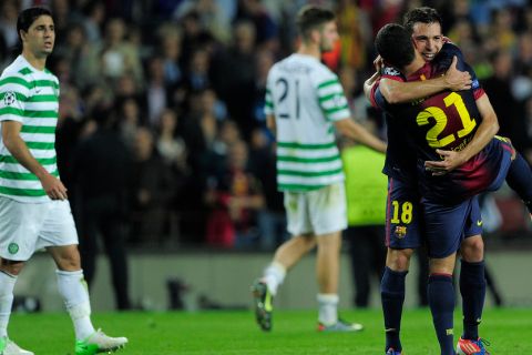 Barcelona's defender Jordi Alba (R) is congratuled by his teammate Brazilian defender Adriano Correia (R) after scoring in the last minute of the UEFA Champions League football match FC Barcelona vs Celtic CF on October 23, 2012 at the Camp Nou stadium in Barcelona.  AFP PHOTO/ JOSEP LAGO        (Photo credit should read JOSEP LAGO/AFP/Getty Images)