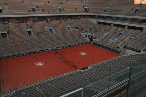 A near empty center court Philippe Chatrier is seen rain interrupted the quarterfinal match of the French Open tennis tournament between Japan's Kei Nishikori and Spain's Rafael Nadal at the Roland Garros stadium in Paris, Tuesday, June 4, 2019. (AP Photo/Pavel Golovkin)