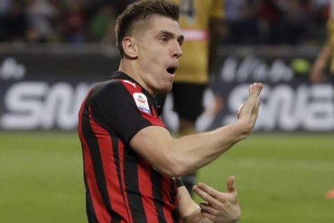 AC Milan's Krzysztof Piatek celebrates after scoring his side's opening goal during the Serie A soccer match between AC Milan and Udinese, at the San Siro stadium in Milan, Italy, Tuesday, April 2, 2019. (AP Photo/Luca Bruno)