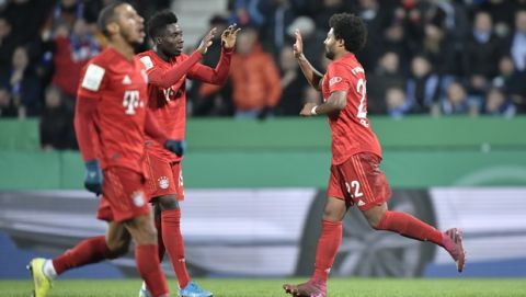 Bayern's Serge Gnabry, right, celebrates after scoring his side's first goal with Alphonso Davies during the German soccer cup, DFB Pokal, second round match between VfL Bochum and Bayern Munich at the Vonovia Ruhrstadion stadium, in Bochum, Germany, Tuesday, Oct. 29, 2019. (AP Photo/Martin Meissner)