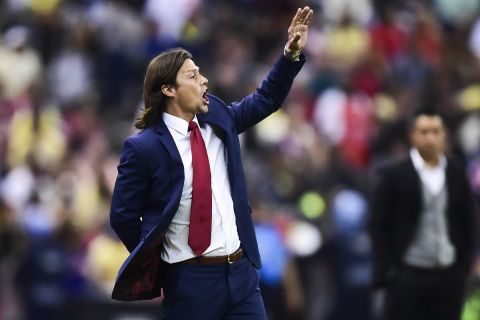 Guadalajaras coach Matias Almeida reacts in a match against America, during their Mexican Apertura 2016 tournament football match, at the Azteca stadium, on August 27, 2016, in Mexico City.