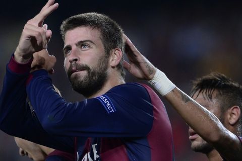 Barcelona's defender Gerard Pique celebrates after scoring during the UEFA Champions League football match FC Barcelona vs APOEL FC at the Camp Nou stadium in Barcelona on September 17, 2014.   AFP PHOTO / JOSEP LAGO        (Photo credit should read JOSEP LAGO/AFP/Getty Images)