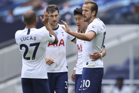 Tottenham's Harry Kane, right, celebrates after scoring his side's second goal during the English Premier League soccer match between Tottenham Hotspur and Leicester City, at the Tottenham Hotspur Stadium in London, Sunday, July 19, 2020. (Richard Heathcote/Pool Photo via AP)