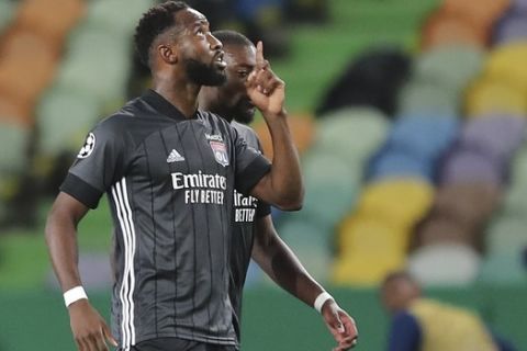 Lyon's Moussa Dembele, left, celebrates after scoring his side's second goal during the Champions League quarterfinal soccer match between Lyon and Manchester City at the Jose Alvalade stadium in Lisbon, Portugal, Saturday, Aug. 15, 2020. (Miguel A. Lopes/Pool via AP)