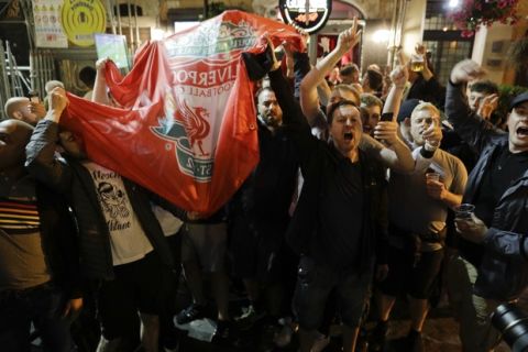 Liverpool supporters sing and wave their team's flag in a pub in Rome's historical Campo de' Fiori square, Tuesday, May 1, 2018. Liverpool will face AS Roma in the second leg of the Champions League semifinals on Wednesday.(AP Photo/Andrew Medichini)