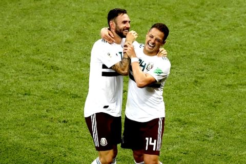 Mexico's Miguel Layun, left, and teammate Javier Hernandez celebrate after their team's 2-1 win over South Korea in their group F match at the 2018 soccer World Cup in the Rostov Arena in Rostov-on-Don, Russia, Saturday, June 23, 2018. (AP Photo/Efrem Lukatsky)