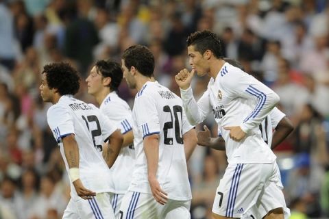 Real Madrid's Portuguese forward Cristiano Ronaldo celebrates (R) after scoring a penalty against Espanyol during a Spanish league football match at the Santiago Bernabeu Stadium, on September 21, 2010 in Madrid. AFP PHOTO/Pedro ARMESTRE (Photo credit should read PEDRO ARMESTRE/AFP/Getty Images)