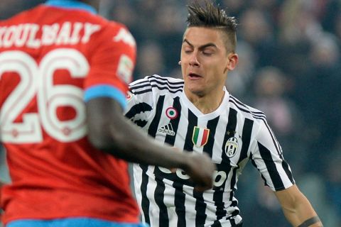 Juventus' Paulo Dybala, right, challenges for the ball with Napoli's Kalidou Koulibaly during a Serie A soccer match between Juventus and Napoli at the Juventus stadium, in Turin, Italy, Saturday, Feb. 13, 2016. (AP Photo/Massimo Pinca)