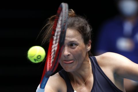 Tatjana Maria of Germany plays a backhand return to Maria Sakkari of Greece during their first round match at the Australian Open tennis championships in Melbourne, Australia, Monday, Jan. 17, 2022. (AP Photo/Hamish Blair)