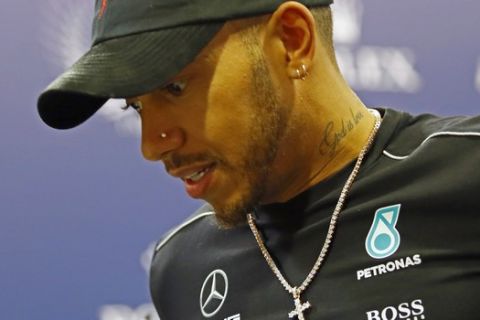F1 world champion Lewis Hamilton attends the press conference of the 2017 FIA Champions in Paris, Friday, Dec. 8, 2017. Mercedes driver Lewis Hamilton credits his car's reliability and a better relationship with his teammate as key factors behind his fourth world title. Hamilton scored points in all Formula One races this season, the first time he has done so. (AP Photo/Francois Mori)