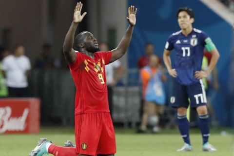 Belgium's Romelu Lukaku kneels at the end of the round of 16 match between Belgium and Japan at the 2018 soccer World Cup in the Rostov Arena, in Rostov-on-Don, Russia, Monday, July 2, 2018. Belgium won 3-2. (AP Photo/Pavel Golovkin)