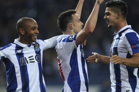 Porto's Diogo Jota, center, celebrates with Andre Silva, right, and Yacine Brahimi after scoring his side's fifth goal during a Champions League group G soccer match between FC Porto and Leicester City at the Dragao stadium in Porto, Portugal, Wednesday, Dec. 7, 2016. (AP Photo/Paulo Duarte)