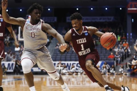 Texas Southern's Donte Clark (1) drives against North Carolina Central's Larry McKnight Jr. (0) during the first half of a First Four game of the NCAA men's college basketball tournament Wednesday, March 14, 2018, in Dayton, Ohio. (AP Photo/John Minchillo)